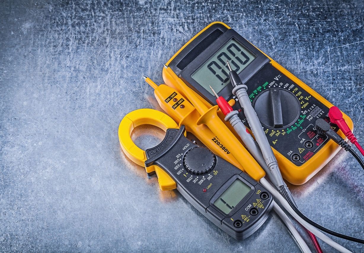 A pair of multimeters and some electrical tools.