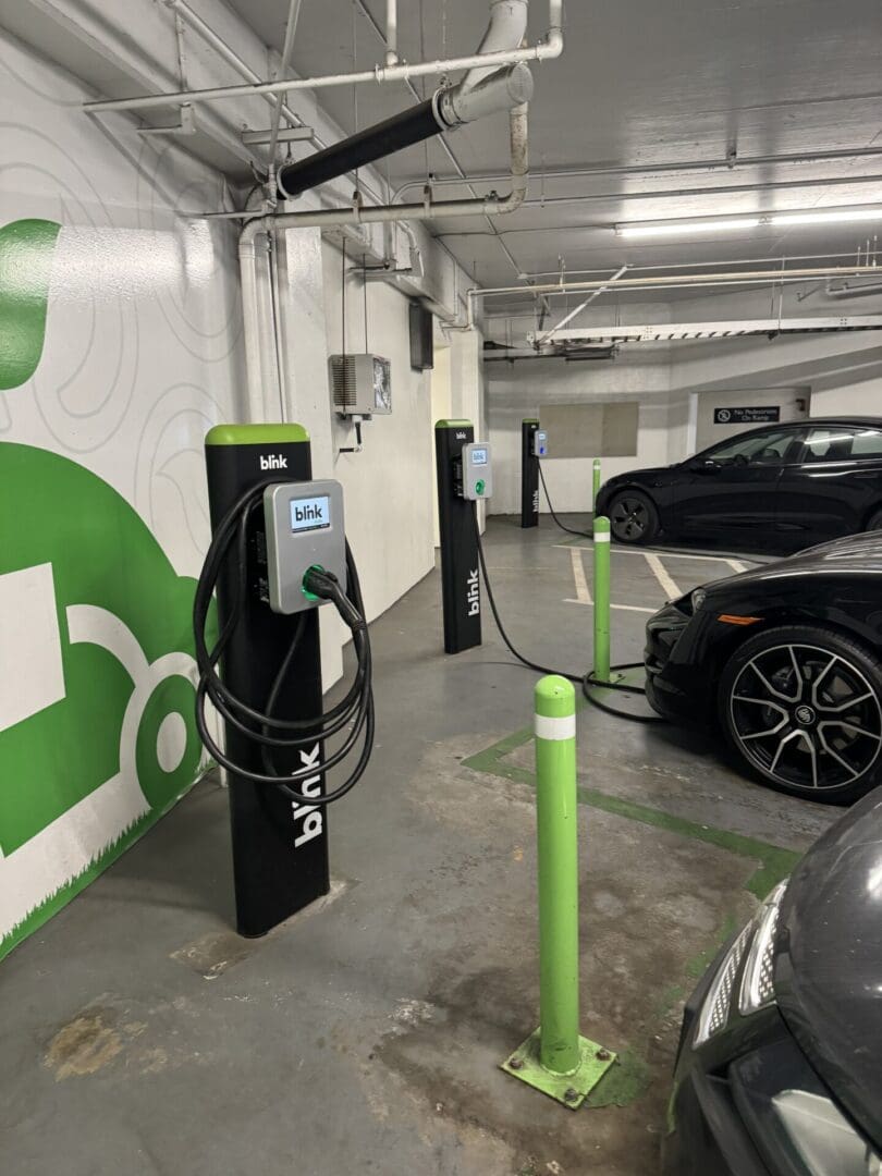 Two Blink EV charging stations in a garage.